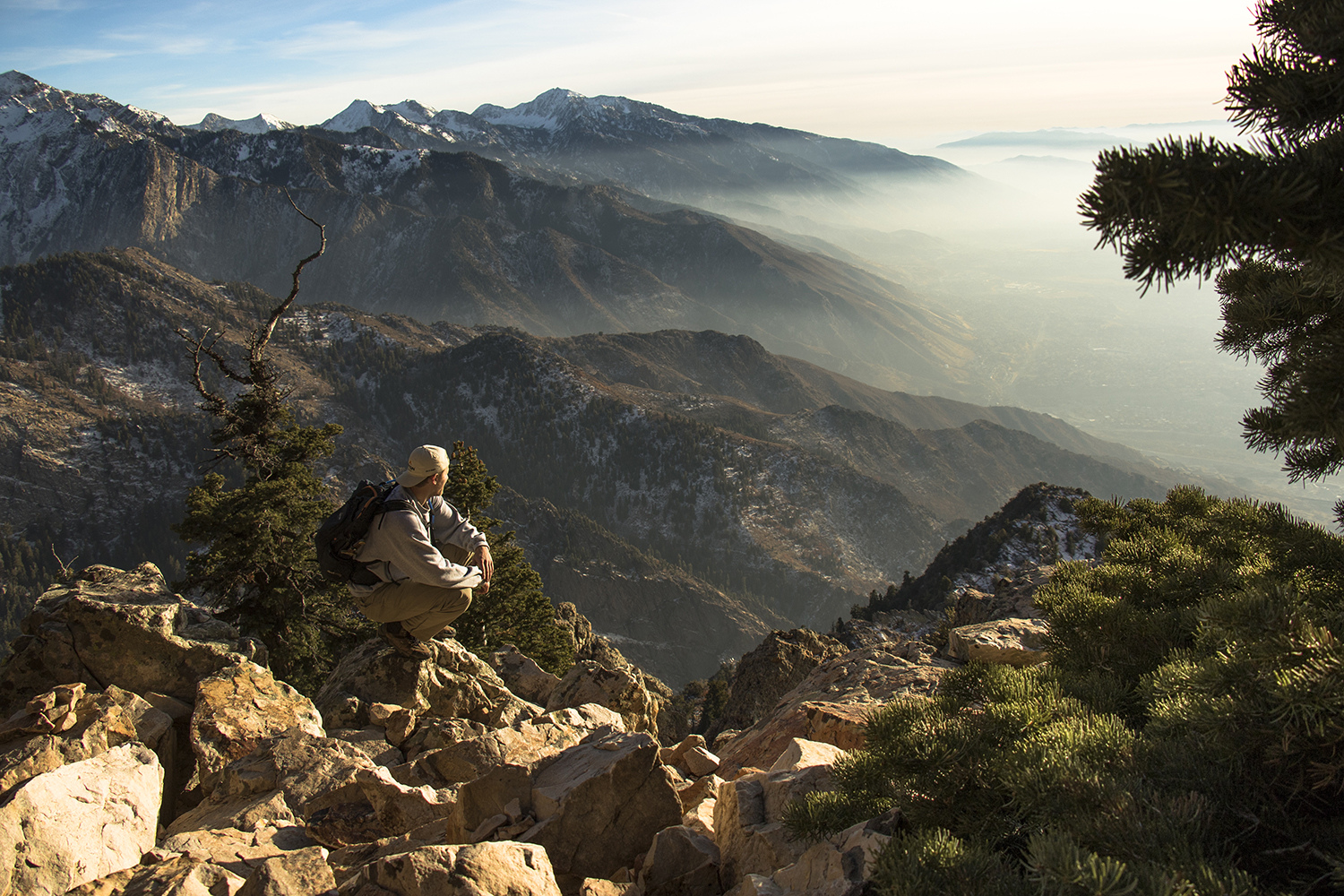Nick Uthe overlooking the Wasatch Mountains from a rocky ridge